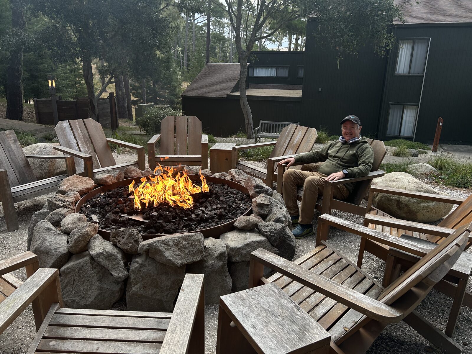 Robert seated at the fire pit in the evening