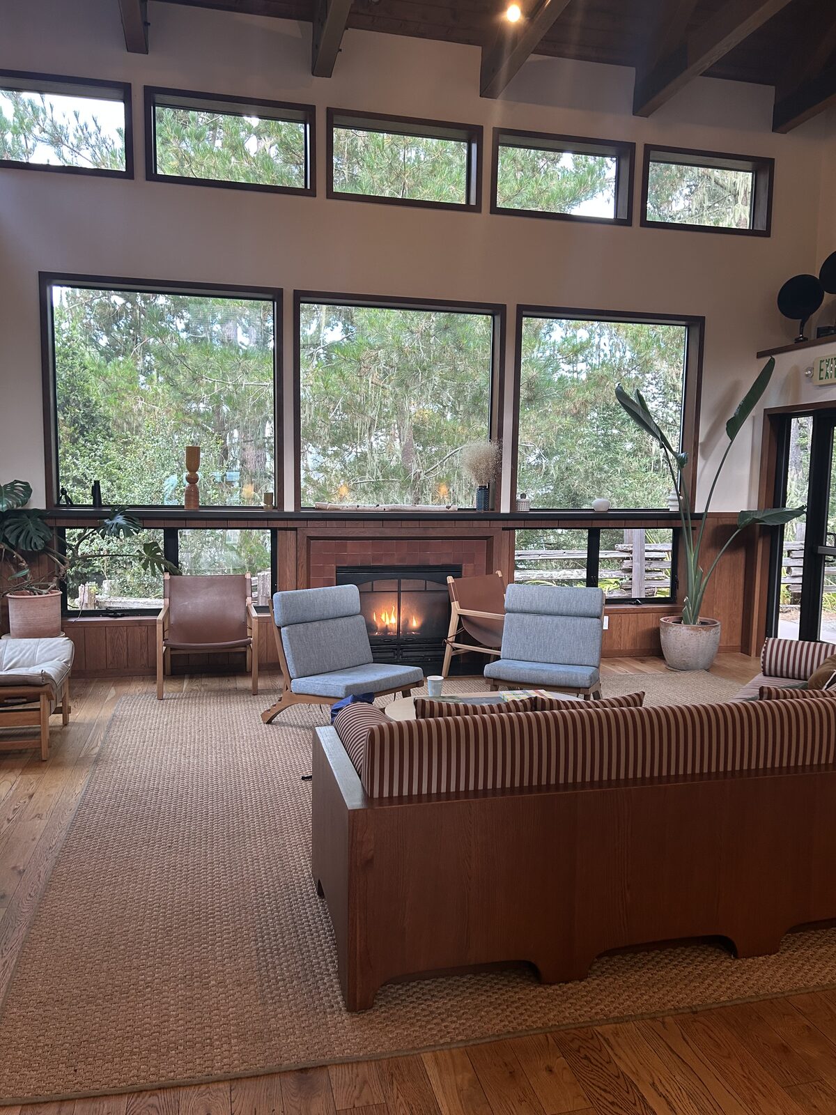 Lodge lounge with fireplace and tall windows