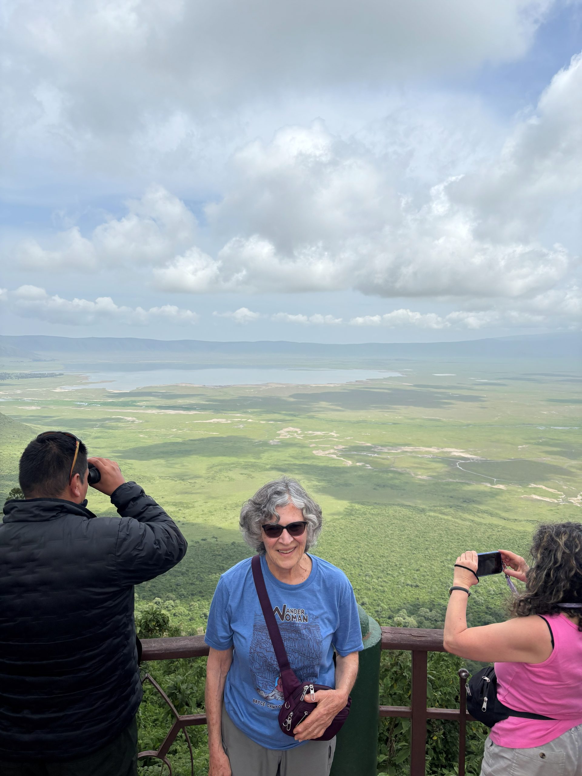 Jo at the Ngorongoro Crater rim overlook, the entire crater floor and lake visible behind her