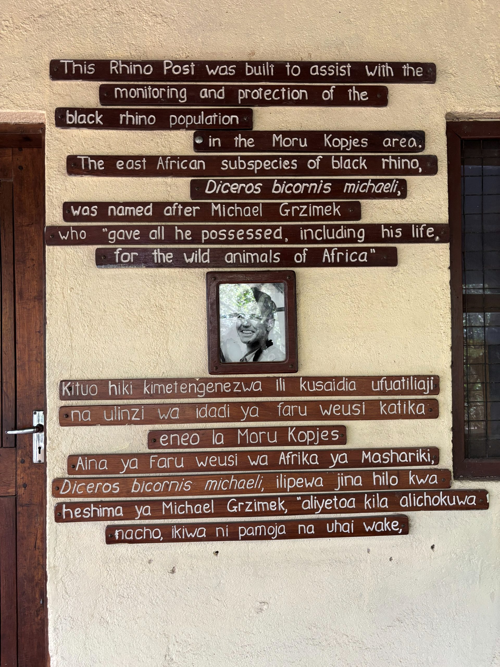 The Moru Kopjes black rhino monitoring post dedication — wooden plaques on a wall honoring Michael Grzimek, who gave his life for the wild animals of Africa